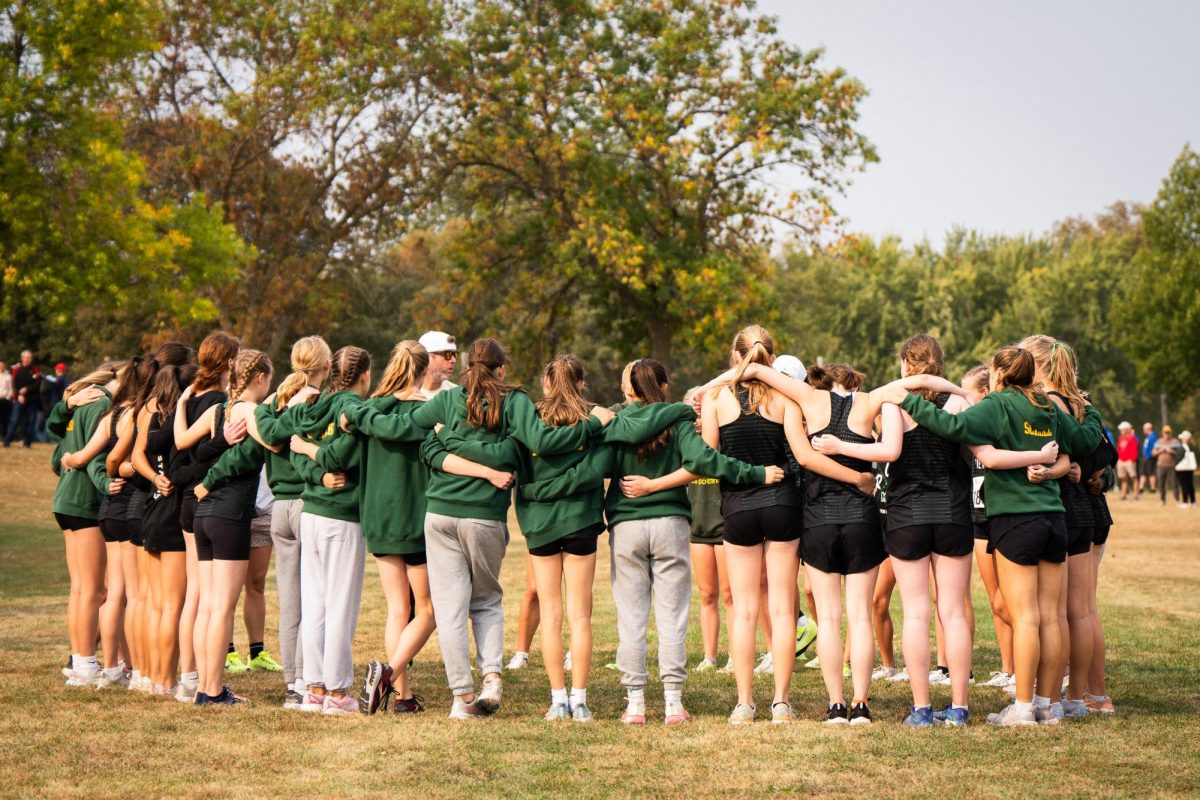 Mounds View girls cross country huddles before their race at Alexandria Lion's Meet of Champions